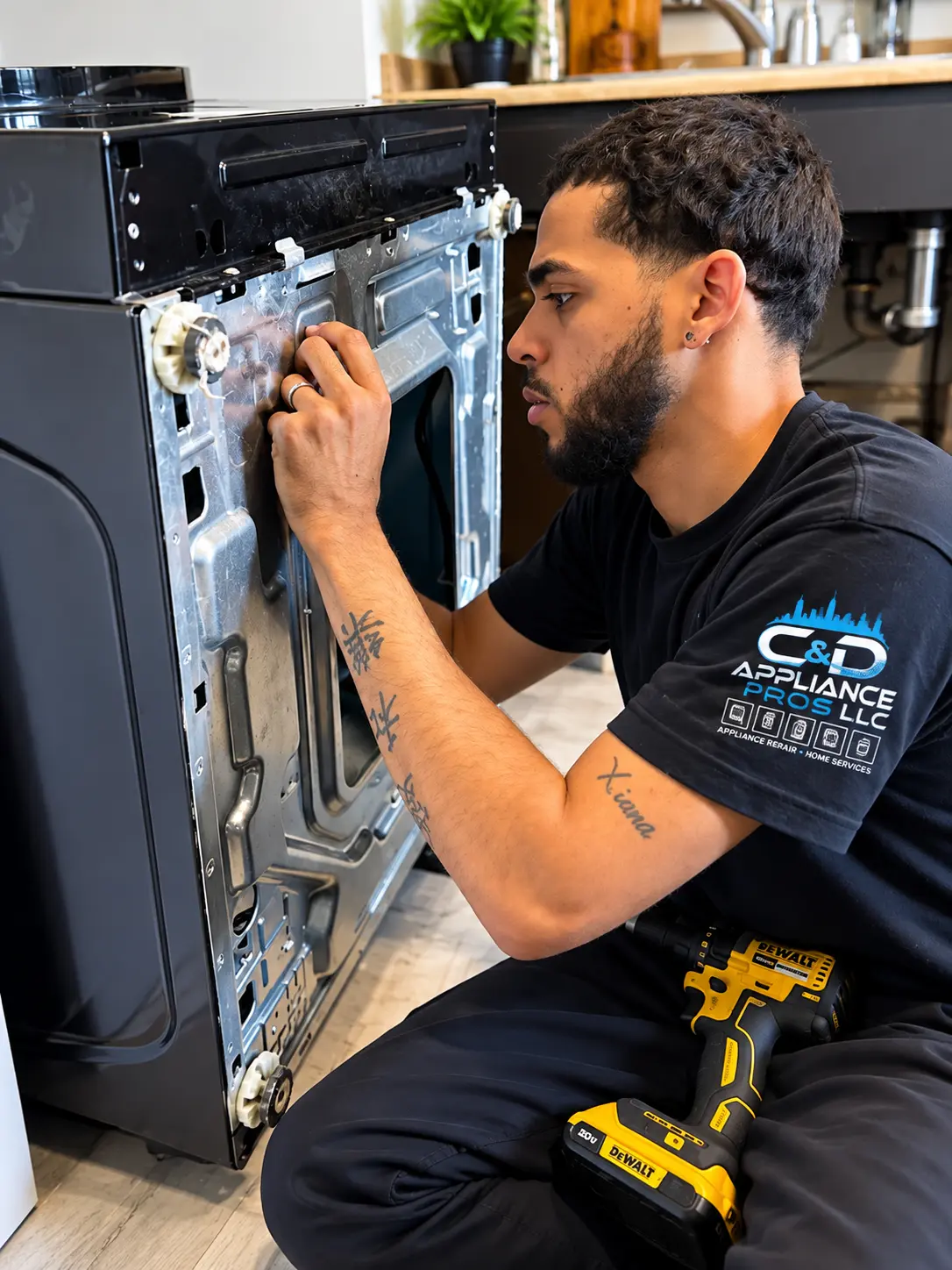 C&D Appliance Pros technician repairing a dryer in a New York kitchen