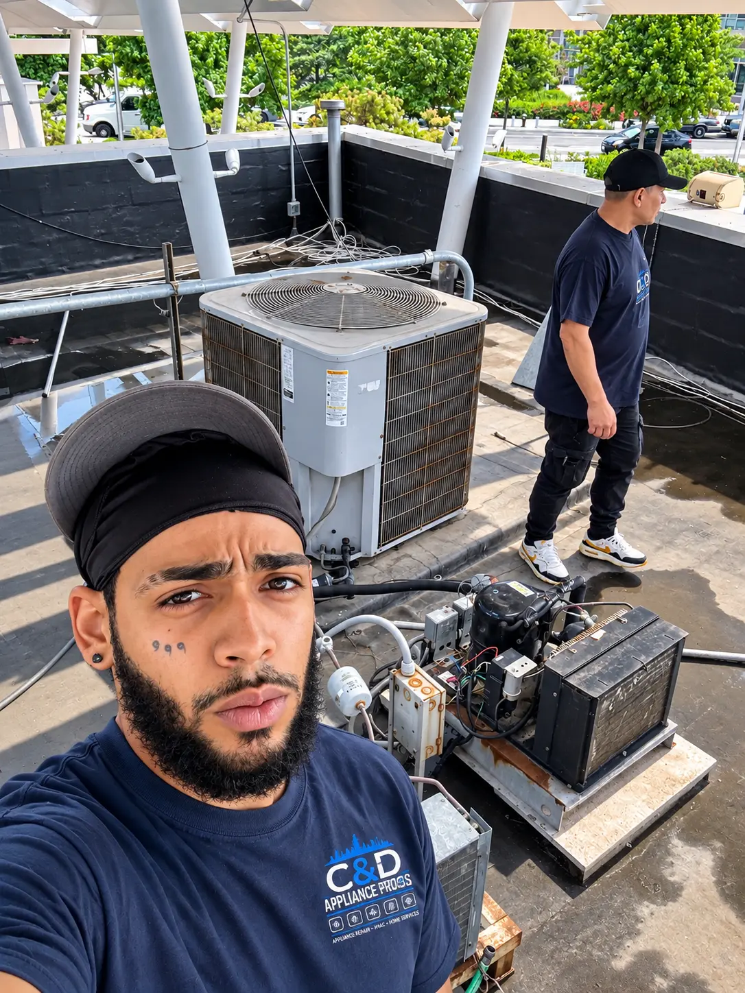 Two C&D Appliance Pros HVAC technicians on a New York rooftop job site